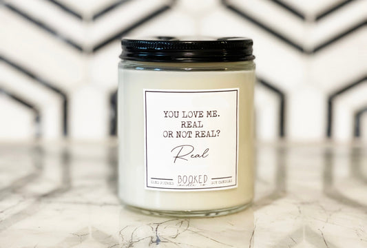 Image of "You Love Me, Real Or Not Real - Hunger Games Series" labelled candle