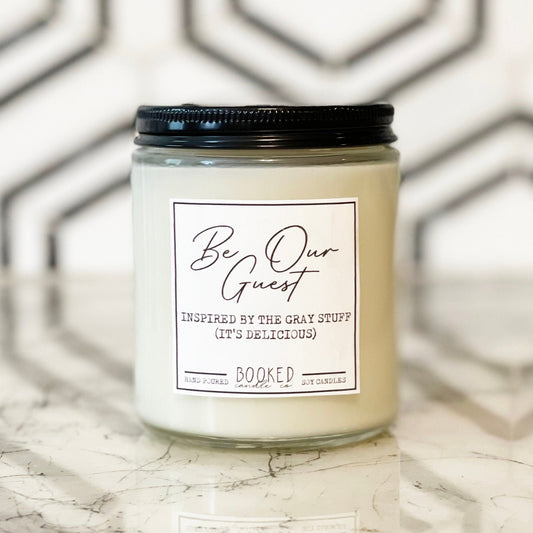 Image of a Disney-inspired quote of "Be Our Guest" from Beauty & the Beast labelled candle