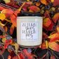 Candle with 'Autumn Skies Pumpkin Pies' label on a decorative wreath with fall leaves and berries